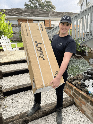 Technician installing a heat pump